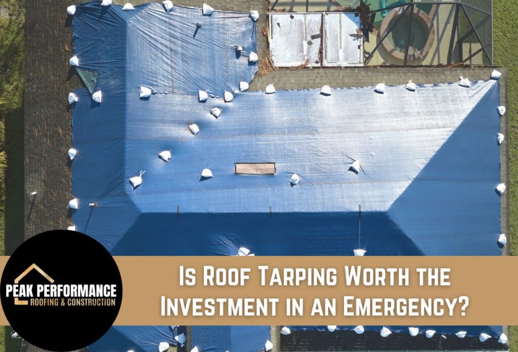 Aerial view of blue tarp covering damaged roof with white sandbags for emergency protection