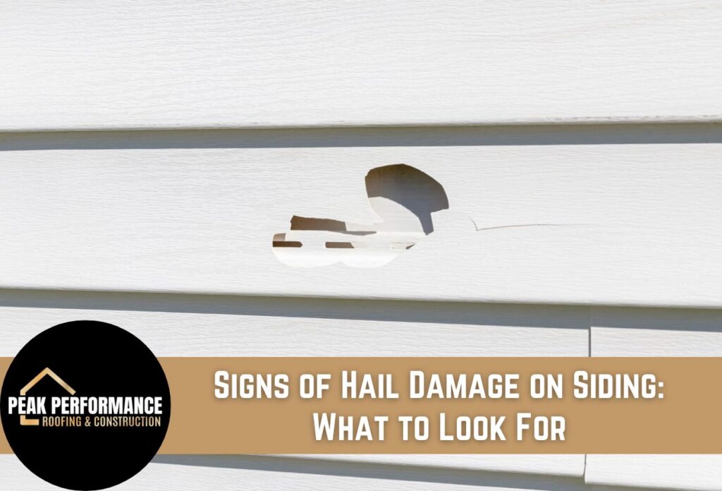 Close-up of hail damage on house siding showing cracking and holes.