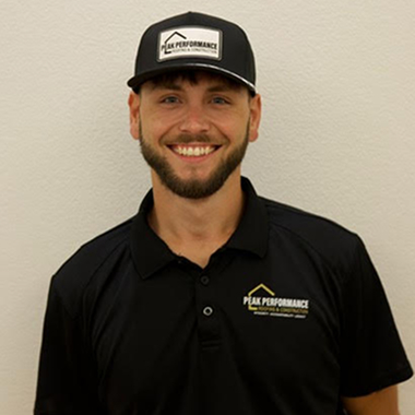 Smiling man in Peak Performance branded cap and shirt