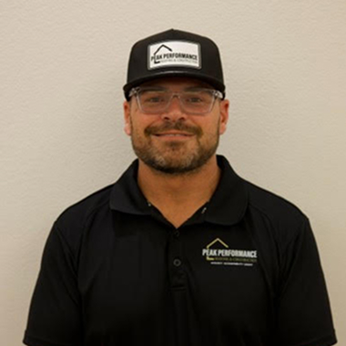 Man wearing a black Peak Performance hat and shirt smiling